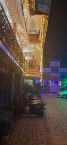 a building with lights on the side of it at night at EVA AYURVEDIC beach hotel in Varkala
