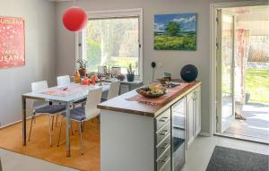 a kitchen with a table with a bowl of fruit on it at Lovely Home In Simrishamn With Wifi in Simrishamn