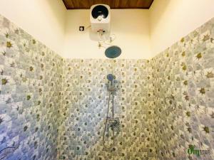 a bathroom with a shower with a shower head at Om Hotel in Unawatuna +43 photos