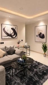 a living room with a couch and a table at Happy Villa هابي فيلا in Al Khobar