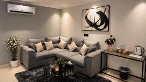 a living room with a couch and a table at Happy Villa هابي فيلا in Al Khobar