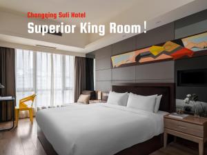 a hotel room with a large white bed in a room at Suli Hotel Chongqing,1 Min Walk to Metro,Near Jiefangbei&Hongya Cave,International guest-friendly,Free Self-Service Laundry,Free High-Speed WiFi,Free Chinese Tea,Free Travel Advice in Chongqing