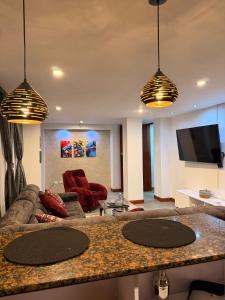 a living room with a couch and a tv at Apartamento T Premium in Ipiales