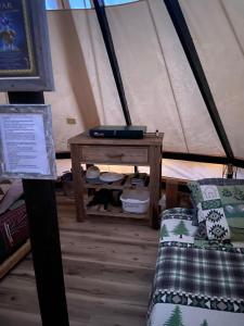 a room with a table and a bed in a tent at Issachar Tent in Duchesne