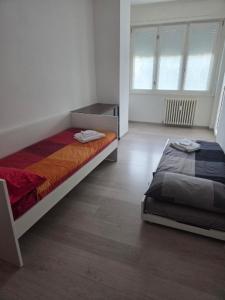 a bedroom with a bed and a window at Il Ciano in Sondrio