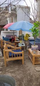 a group of benches and a blue umbrella at T-Suru Hotel & Cafe Leh in Leh