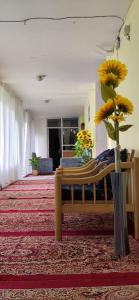 a room with a bench and a vase with flowers at T-Suru Hotel & Cafe Leh in Leh +26 photos