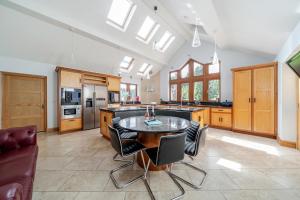 a large kitchen with a table and chairs in it at Manor House in Chesterfield
