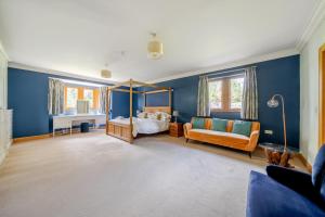 a bedroom with blue walls and a bed and a mirror at Manor House in Chesterfield