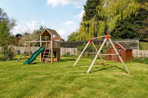 a yard with a playground with two swings at Manor House in Chesterfield