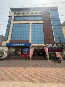 a tall building with a hotel center your apartment and a sign at Hotel Centre Point in Gorakhpur