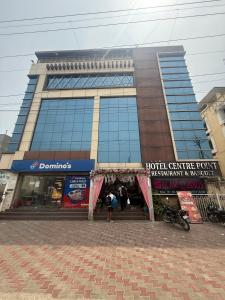 a large building with people standing outside of it at Hotel Centre Point in Gorakhpur