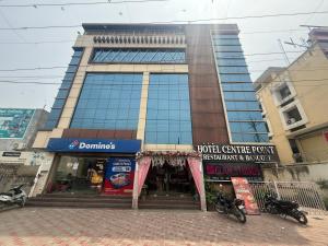a tall building with a store in front of it at Hotel Centre Point in Gorakhpur