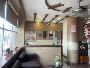 a lobby with a waiting room with a couch at Hotel Centre Point in Gorakhpur