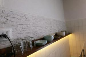 a kitchen counter with bowls and dishes on it at Celestial crest in Pune +23 photos