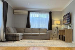a living room with a couch and a window at Healy Retreat in Mary Kathleen