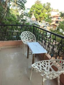 a balcony with a table and chairs on a balcony at 1 Bhk apartment kyle garden baga beech in Baga