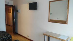a mirror on the wall of a room at Hospedaje Covadonga in Gijón