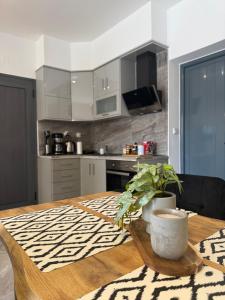a kitchen with a wooden table with a plant on it at Eunoia Homestay & BnB - Loutra Pozar, Aridaia in Aridaia