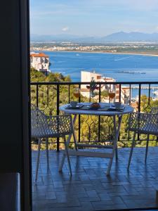 a table on a balcony with a view of the water at Puig Rom Pau Vila in Roses