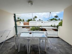 a balcony with a table and two chairs on it at Le Papangue in Saint-Paul
