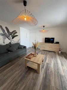 a living room with a couch and a coffee table at Le Papangue in Saint-Paul