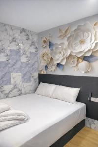 a bedroom with a wall with flowers on it at ARK Port Dickson Seafront Hotel in Port Dickson +3 photos