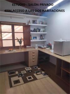 an office with a desk and a rug on the floor at Sun & Palm Trees in Balsares