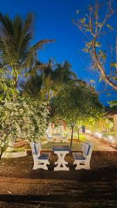a picnic table and chairs in a park at night at pra tiksha farm in Karjat