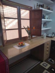 a kitchen counter with a plate of fruit on it at Sun & Palm Trees in Balsares