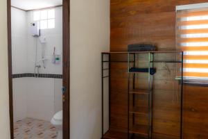 a bathroom with a toilet and a glass shelf at โอโซนริมน้ำเขาใหญ่ in Ban Pang Kae +33 photos