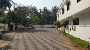 a parking lot in front of a building at Hotel Afrad International in Kondotti