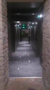 a hallway in a building with a dark corridor at Hostellerie Saint Germain in Saint-Germain-lès-Arlay