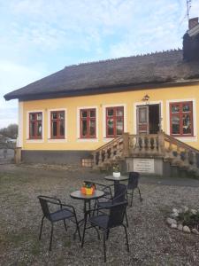 a house with a table and chairs in front of it at Strandhgarden B&B Cozy Room near Malmo in Oxie +10 photos