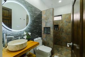 a bathroom with a sink and a toilet and a mirror at Creekside Lofts #1 in Fortuna +12 photos