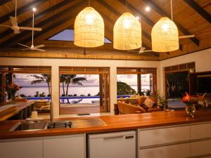 a kitchen with a view of the ocean at Mokusiga Villas in Tangangge