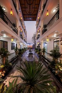 an empty lobby with tables and potted plants at Tam Coc Diamond Premium Hotel & Spa in Vũ Lâm +64 photos