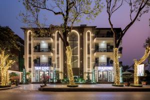 a building with christmas lights in front of it at Tam Coc Diamond Premium Hotel & Spa in Vũ Lâm