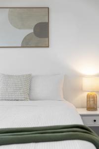 a bedroom with a bed and a picture on the wall at Elevated 2BR & Sofa Bed Apartment in the Heart of Prospect in Prospect