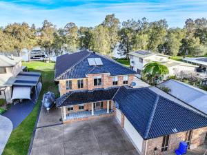 an overhead view of a house with a blue roof at Grandwater Escape in Dora Creek