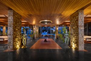 a lobby of a resort with a table and chairs at The Rockwall Boutique Hotel Bentota in Bentota