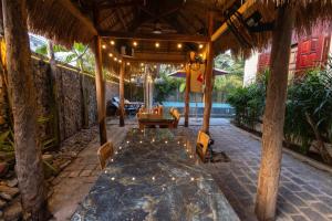 a dining room in a resort with a table and chairs at Banyan Villa Nha Trang in Nha Trang +55 photos