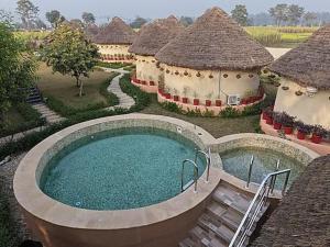 an aerial view of a building with a swimming pool at Forest Mud Villas in Haridwār