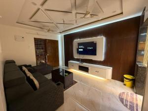 a living room with a couch and a flat screen tv at sun vacation resort in Visakhapatnam