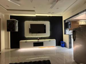 a living room with a television on a wall at sun vacation resort in Visakhapatnam