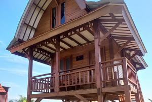 a tree house with a balcony on top of it at Cozzy D'Sobahan Resort in Ngadirejo