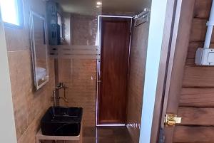 a bathroom with a shower with a sink and a toilet at Cozzy D'Sobahan Resort in Ngadirejo