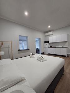 a large white bedroom with a large white bed at The Rec Hotel Waroona in Waroona