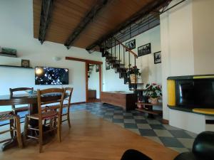 a dining room and living room with a table and chairs at B&B Ca' Vecchia in Budrio