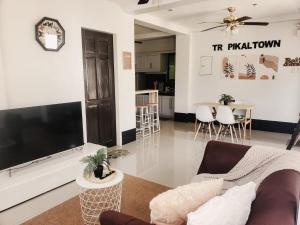 a living room with a large flat screen tv at El Kim Suites in Boac